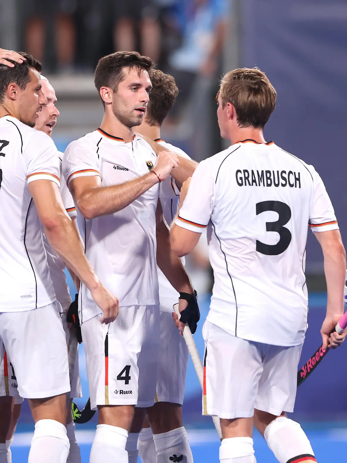 TOKYO, JAPAN - JULY 24: Lukas Windfeder of Team Germany celebrates with teammate Mats Jurgen Grambusch after scoring their team's fourth goal during the Men's Preliminary Pool B match between Canada and Germany on day one of the Tokyo 2020 Olympic Games at Oi Hockey Stadium on July 24, 2021 in Tokyo, Japan. (Photo by Alexander Hassenstein/Getty Images)