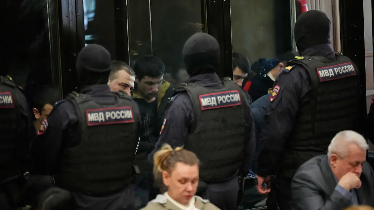 Men tried on the charges of involvement in a terror attack at the Crocus City Hall in March 2024 listen to the verdict in a glass cage at the Second Western District Military Court in Moscow, Russia, Thursday, March 12, 2026. (AP Photo/Pavel Bednyakov)