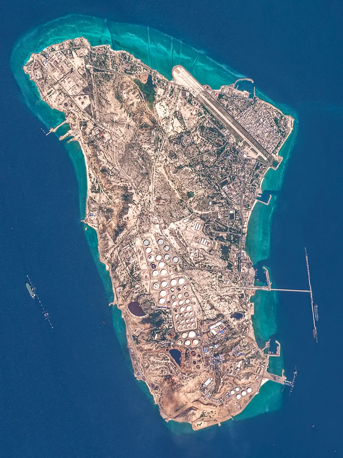 This handout image taken by the European Space Agency (ESA) captured by the Copernicus Sentinel-2 satellite shows a view of Iran's Kharg Island, which hosts the countrys main crude export terminal and is responsible for the overwhelming majority of its oil shipments to the world, about 30 kilometres south of the mainland in the north of the Gulf, on March 7, 2026. The US and Israel have previously treaded carefully around the island in the conflict, but an Axios report over the weekend cited Trump administration officials saying capturing Kharg was on the table. The island handles roughly 90 percent of Iran's crude exports, according to a JP Morgan note released on March 8. (Photo by EUROPEAN SPACE AGENCY / AFP) / RESTRICTED TO EDITORIAL USE - MANDATORY CREDIT "AFP PHOTO / ESA" - HANDOUT - NO MARKETING NO ADVERTISING CAMPAIGNS - DISTRIBUTED AS A SERVICE TO CLIENTS
