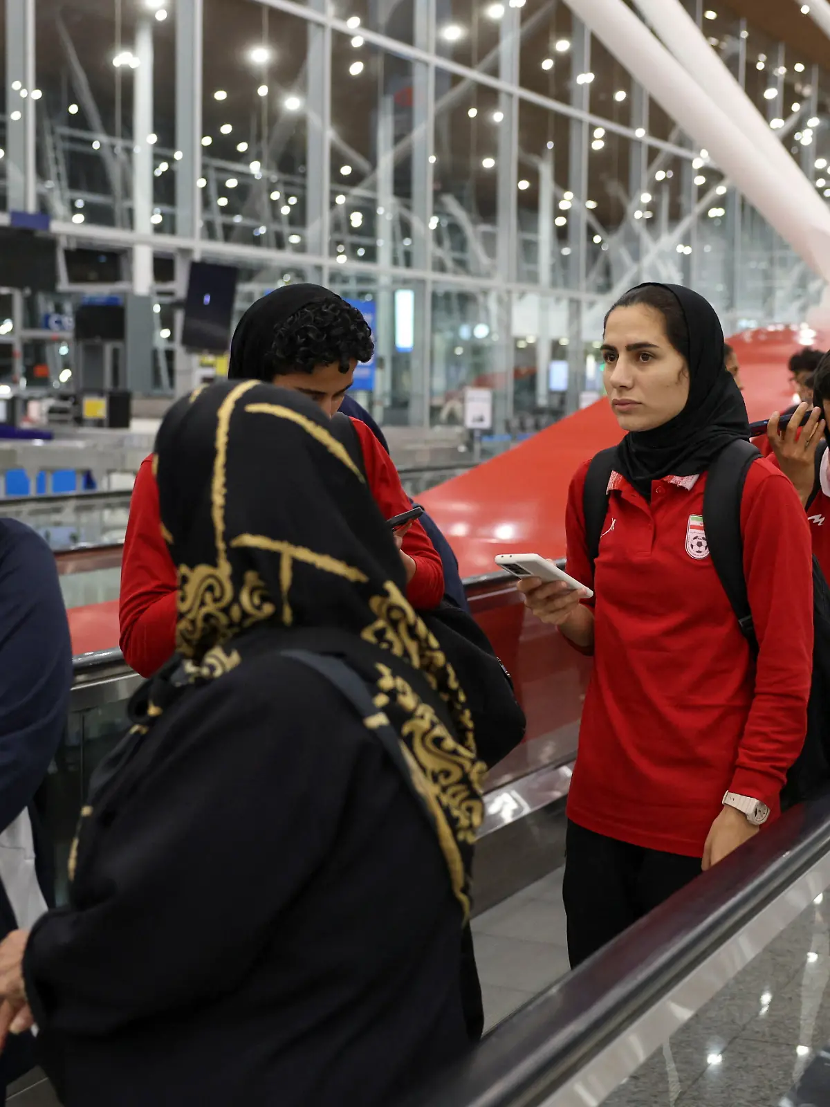 Members of the Iranian women's national soccer team arrive at Terminal 1 of Kuala Lumpur International Airport after attending a match in Group A of the AFC Women's Asian Cup in Australia, at Sepang, Malaysia, March 11, 2026. REUTERS/Hasnoor Hussain