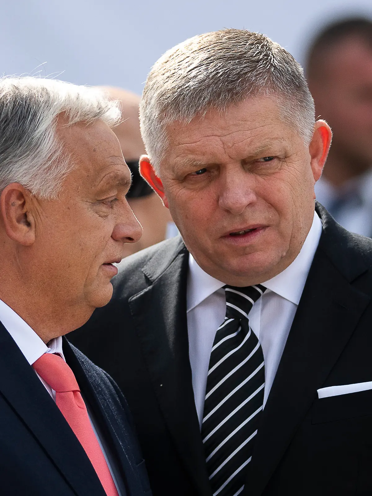 Hungary's Prime Minister Viktor Orban, left, and his Slovakian counterpart Robert Fico talk to each other before delivering their speeches during the 130th anniversary celebration of Mária Valeria Bridge in Esztergom, Hungary, on Sunday, Sept. 28, 2025. (AP Photo/Denes Erdos)