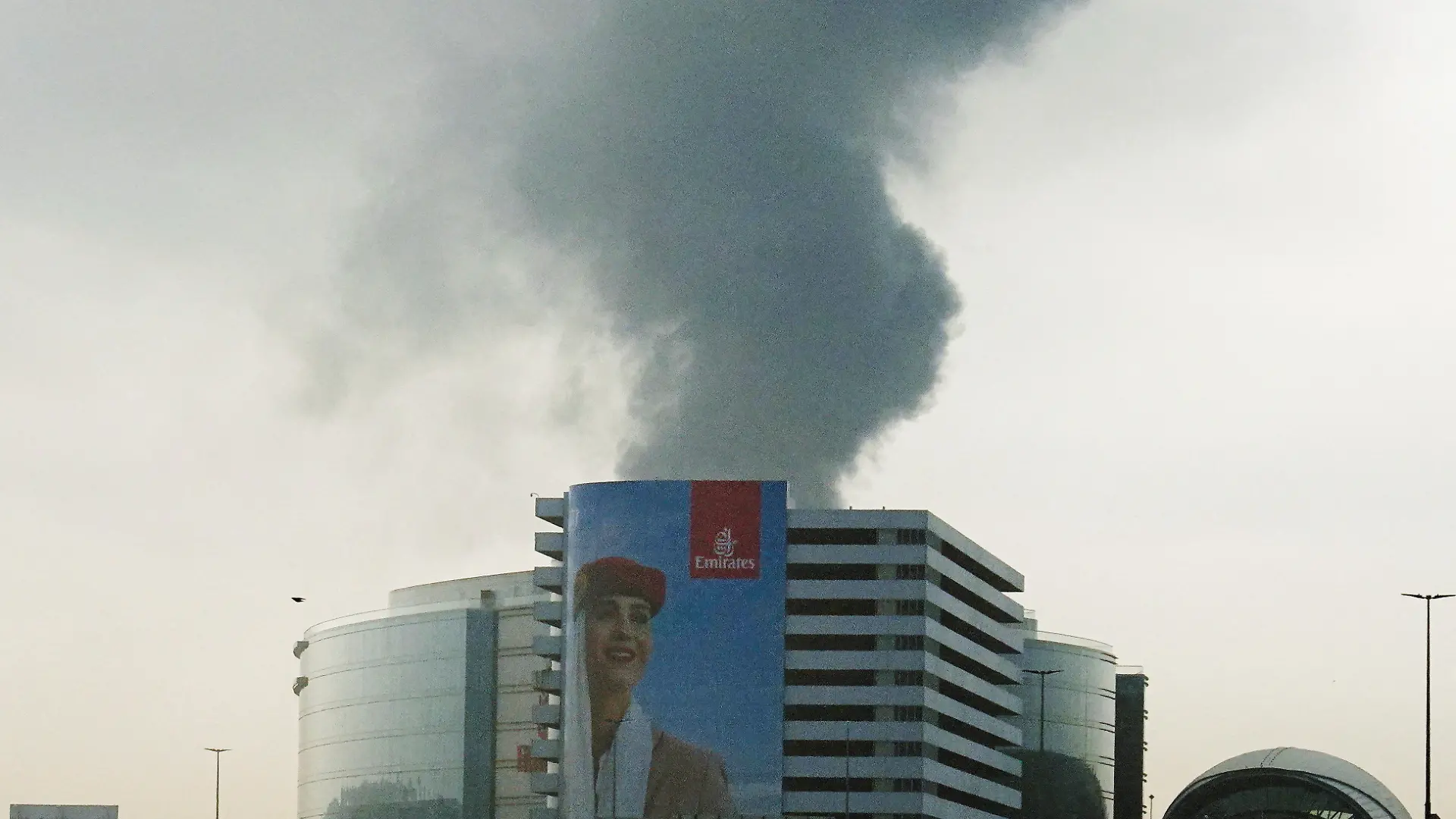 Smoke rises from the Dubai International Airport