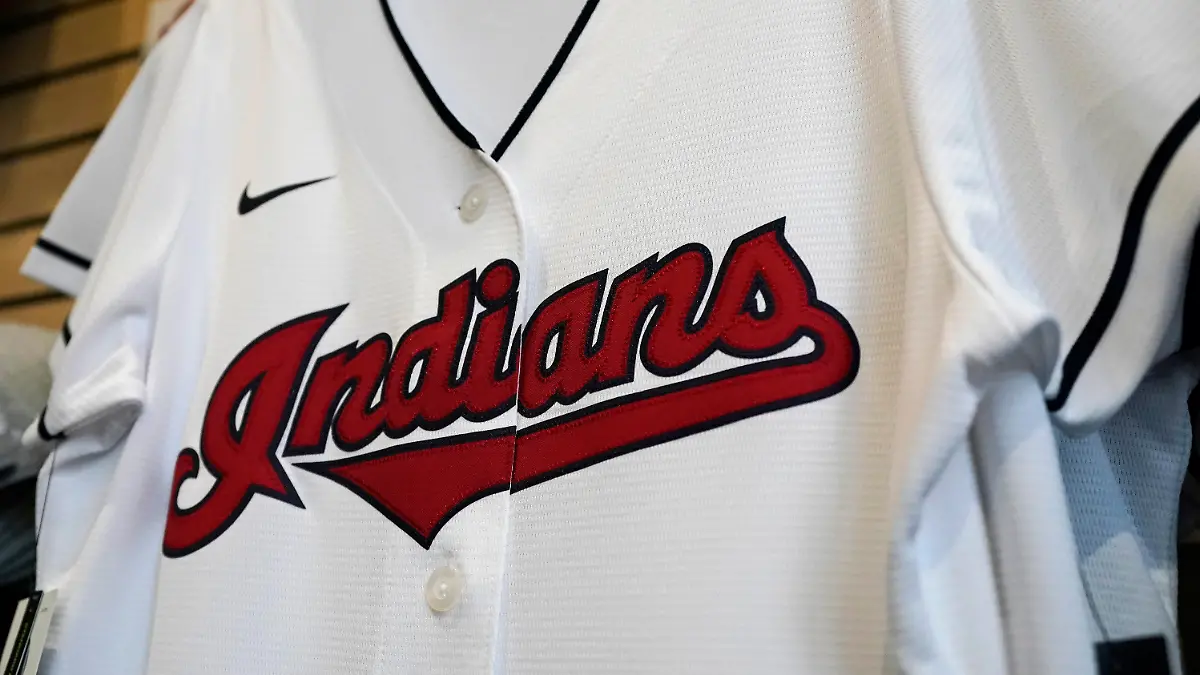FILE - A Cleveland Indians jersey hangs at the Cleveland Indians team shop in Cleveland, in this Wednesday, Dec. 16, 2020, file photo. Known as the Indians since 1915, Cleveland’s Major League Baseball team will be called Guardians. The ballclub announced the name change Friday, July 23, 2021, with a video on Twitter narrated by actor Tom Hanks, ending months of internal discussions triggered by a national reckoning by institutions and teams to permanently drop logos and names considered racist. (AP Photo/Tony Dejak, File)