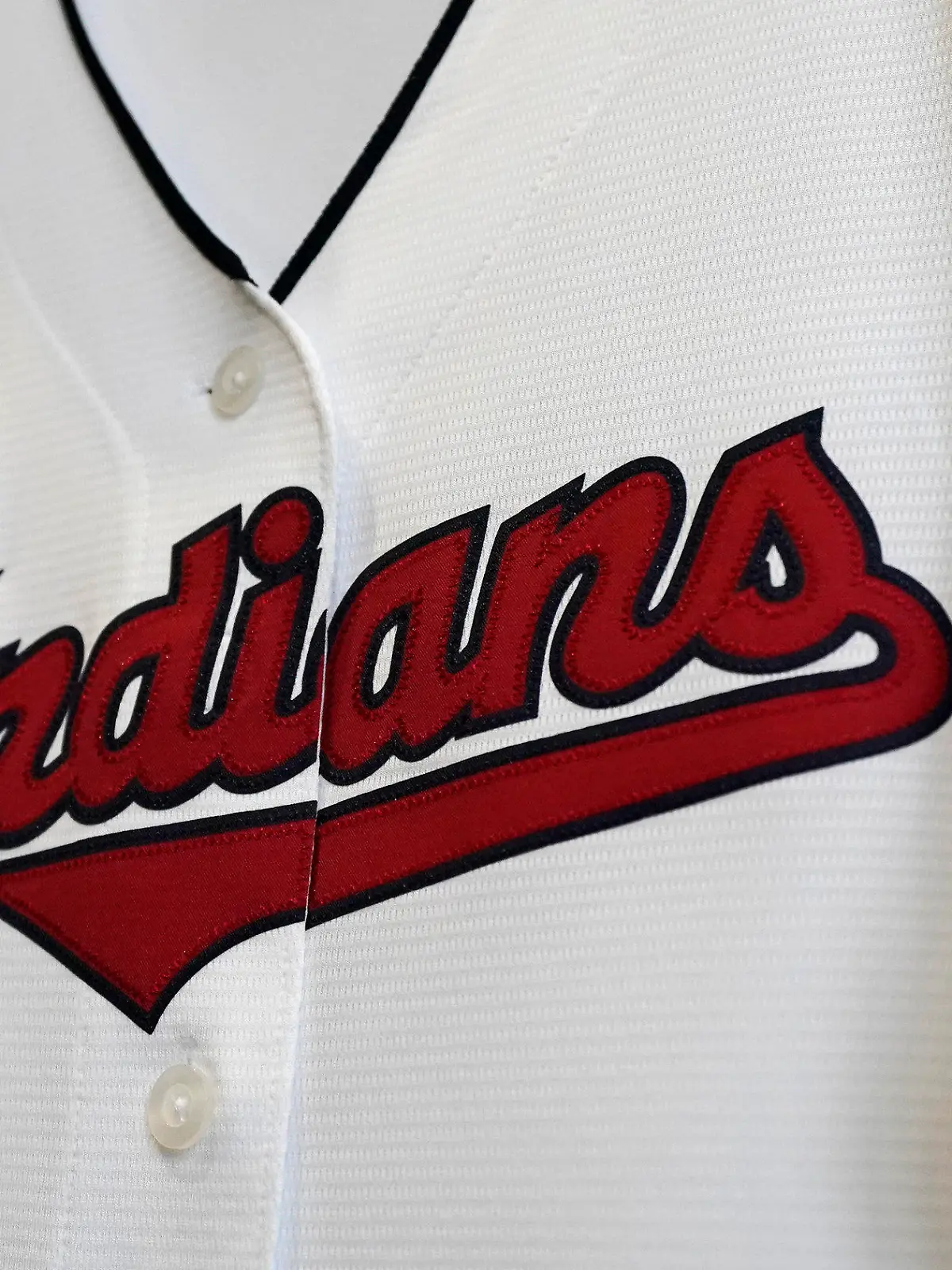 FILE - A Cleveland Indians jersey hangs at the Cleveland Indians team shop in Cleveland, in this Wednesday, Dec. 16, 2020, file photo. Known as the Indians since 1915, Cleveland’s Major League Baseball team will be called Guardians. The ballclub announced the name change Friday, July 23, 2021, with a video on Twitter narrated by actor Tom Hanks, ending months of internal discussions triggered by a national reckoning by institutions and teams to permanently drop logos and names considered racist. (AP Photo/Tony Dejak, File)