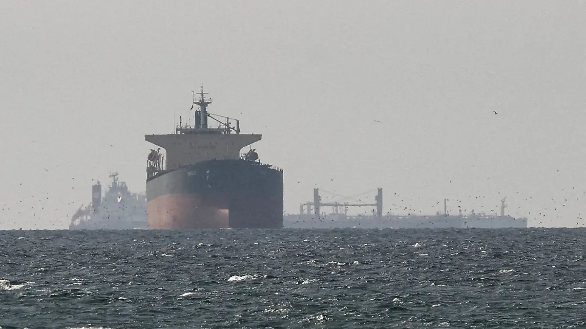 FILE PHOTO: Cargo ships in the Gulf, near the Strait of Hormuz, as seen from northern Ras al-Khaimah, near the border with Oman’s Musandam governance, amid the U.S.-Israeli conflict with Iran, in United Arab Emirates, March 11, 2026. REUTERS/Stringer/File Photo REFILE - CORRECTING "TANKERS" TO "CARGO SHIPS" AND REMOVING ACTION "SAIL".