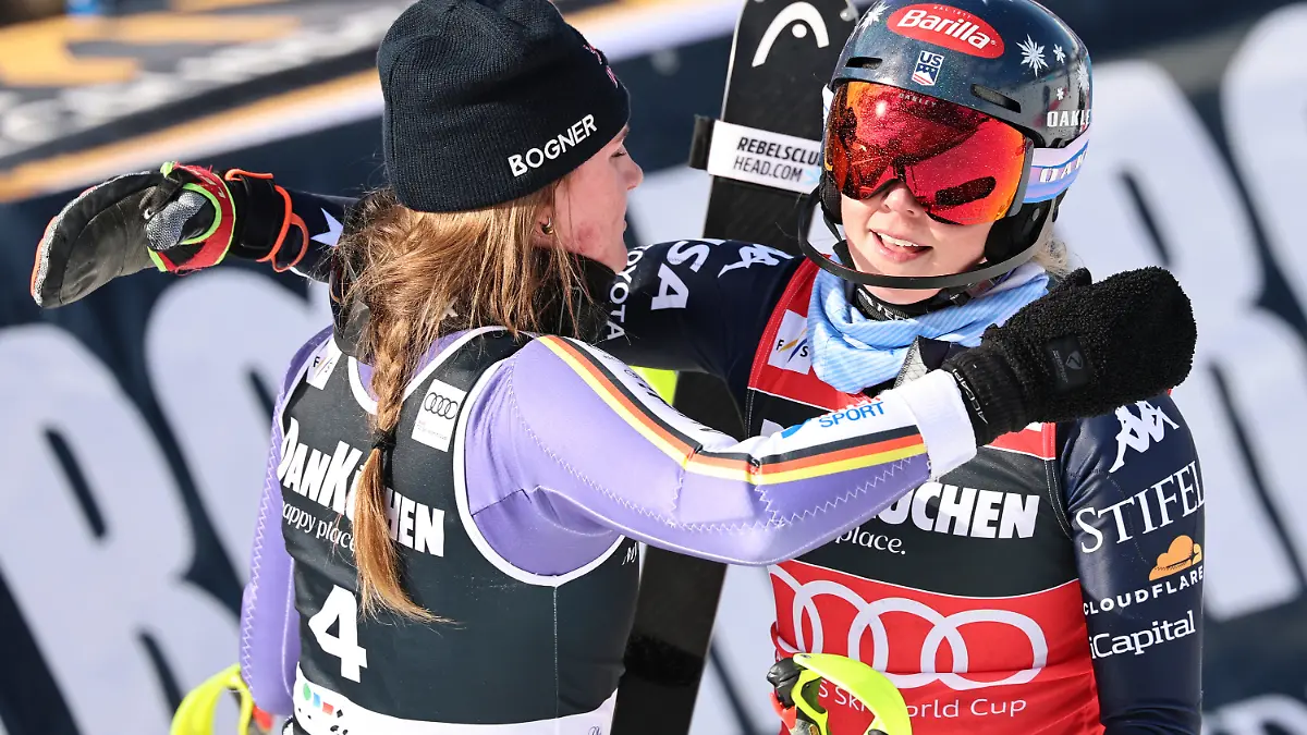 Germany's Emma Aicher, left, and United States' Mikaela Shiffrin hug each other at the finish area of an alpine ski, women's slalom race, at the Lillehammer World Cup Finals, in Hafjell, Norway, Tuesday, March 24, 2026. (AP Photo/Marco Trovati)