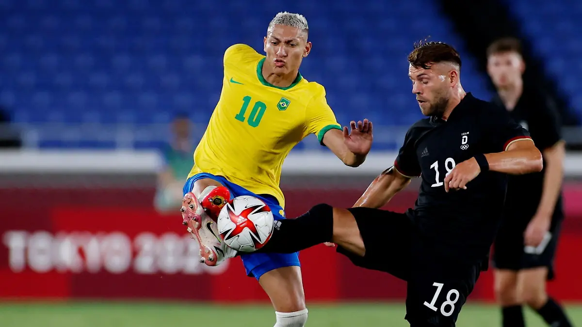 Tokyo 2020 Olympics - Soccer Football - Men - Group D - Brazil v Germany - International Stadium Yokohama, Yokohama, Japan - July 22, 2021. Richarlison of Brazil in action with Eduard Loewen of Germany REUTERS/Phil Noble