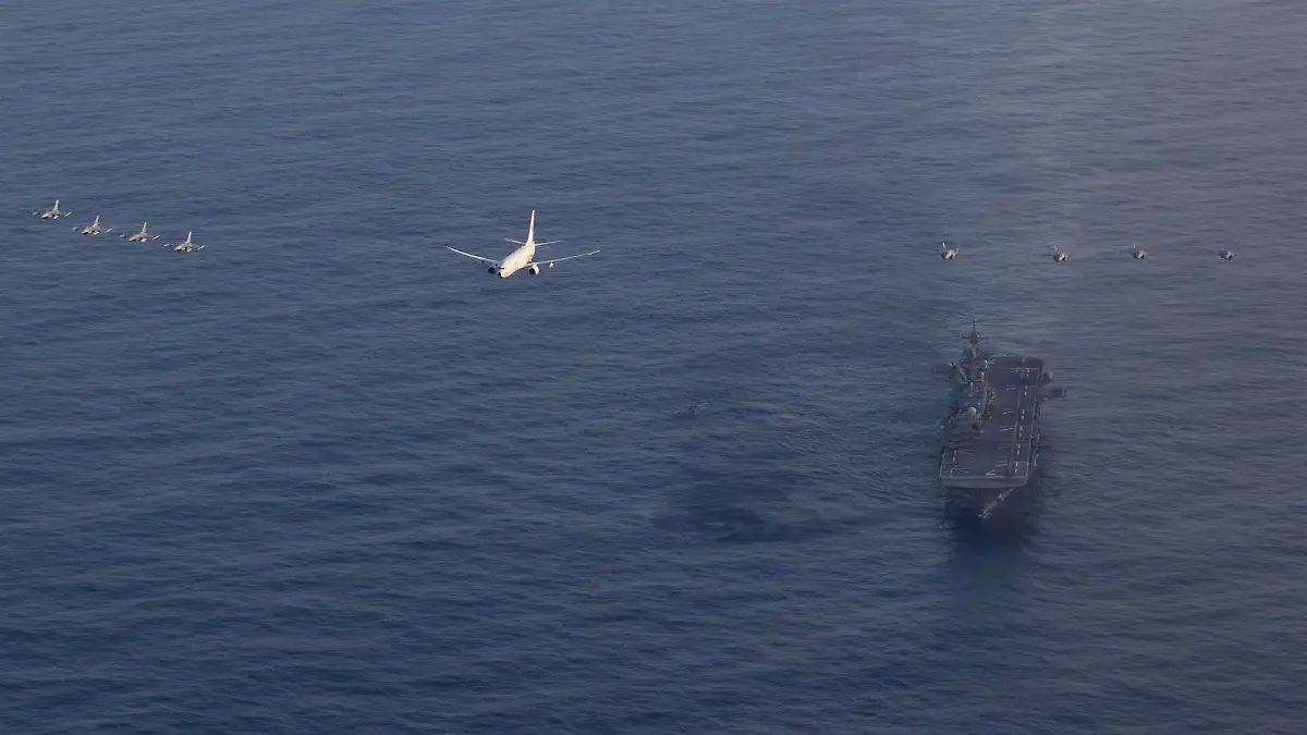 The amphibious assault carrier, USS Tripoli (LHA 7) executes a joint fly over mission consisting of U.S. Marine Corps, Navy and Air Force aircraft, in the Philippine Sea, Feb. 26, 2026. The fly over was conducted to demonstrate the interoperability among U.S. military services in a deployed environment. The 31st MEU is a persistent, combat credible force operating aboard the ships of the Tripoli Amphibious Ready Group in the U.S. 7th Fleet area of operations, routinely interacting and operating with our allies and partners to contribute to deterrence, security, crisis response and combat operations in the Indo-Pacific region. (U.S. Marine Corps photo by Lance Cpl. Raul Sotovilla) (U.S. Navy via SIPA PRESS)/ SIPA PROVIDES ACCESS TO THIS PUBLICLY DISTRIBUTED HANDOUT PHOTO PROVIDED BY U.S. CENTRAL COMMAND//04SIPA_Sipa.24642/Credit:U.S. Navy Photo/SIPA/2603041745
