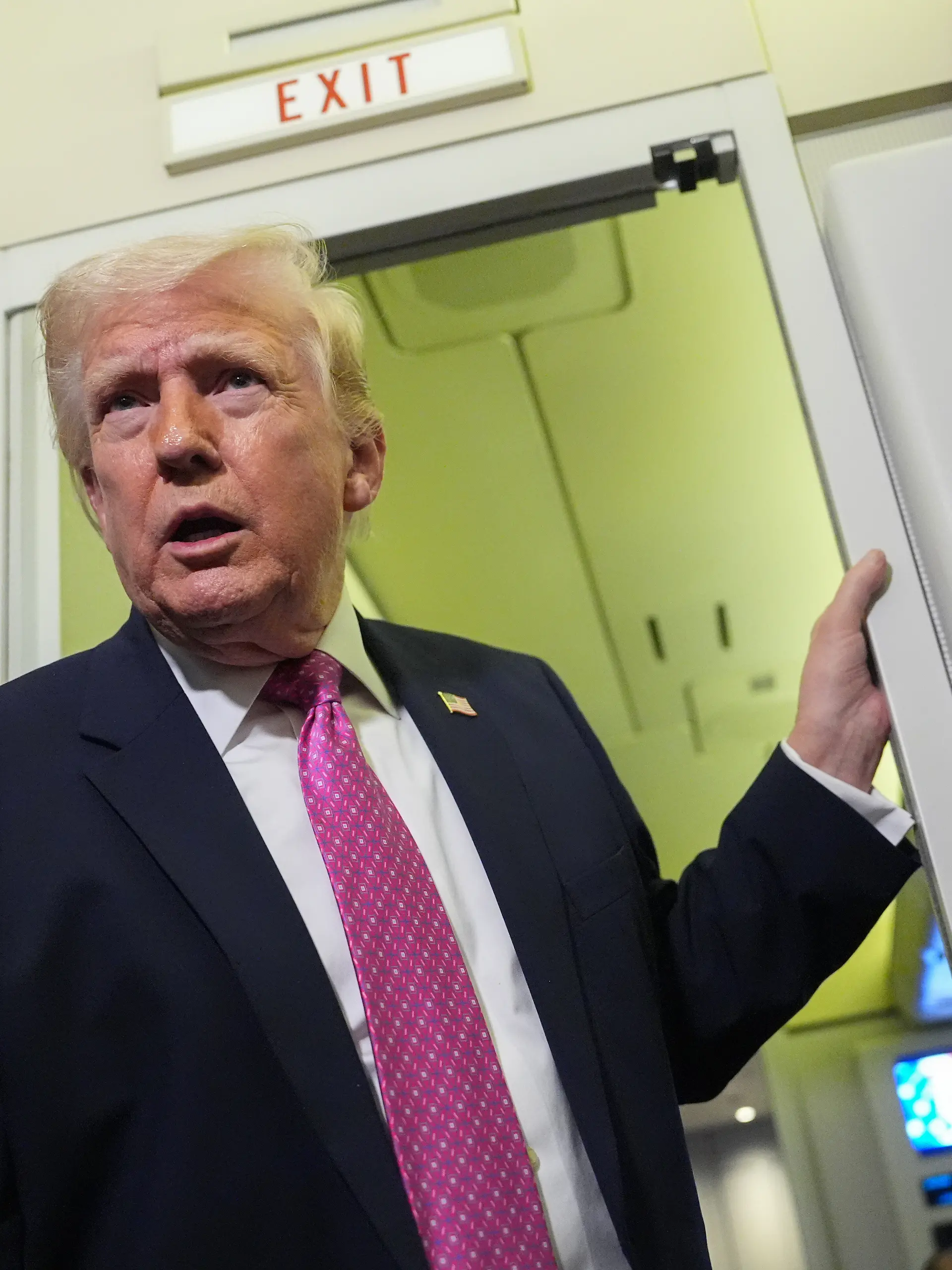 President Donald Trump speaks to reporters aboard Air Force One en route from West Palm Beach, Fla., to Joint Base Andrews, Md., Sunday, March 29, 2026. (AP Photo/Mark Schiefelbein)