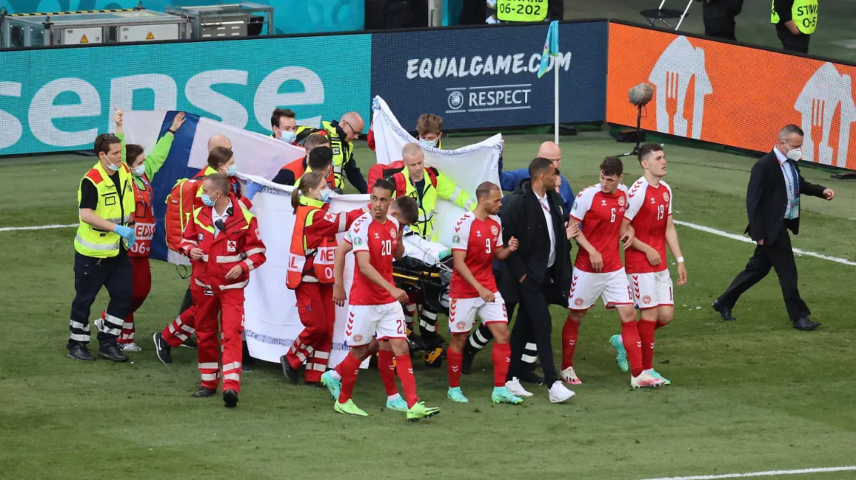Paramedics using a stretcher to take out of the pitch Denmark's Christian Eriksen after he collapsed during the Euro 2020 soccer championship group B match between Denmark and Finland at Parken stadium in Copenhagen, Denmark, Saturday, June 12, 2021. (Wolfgang Rattay/Pool via AP)