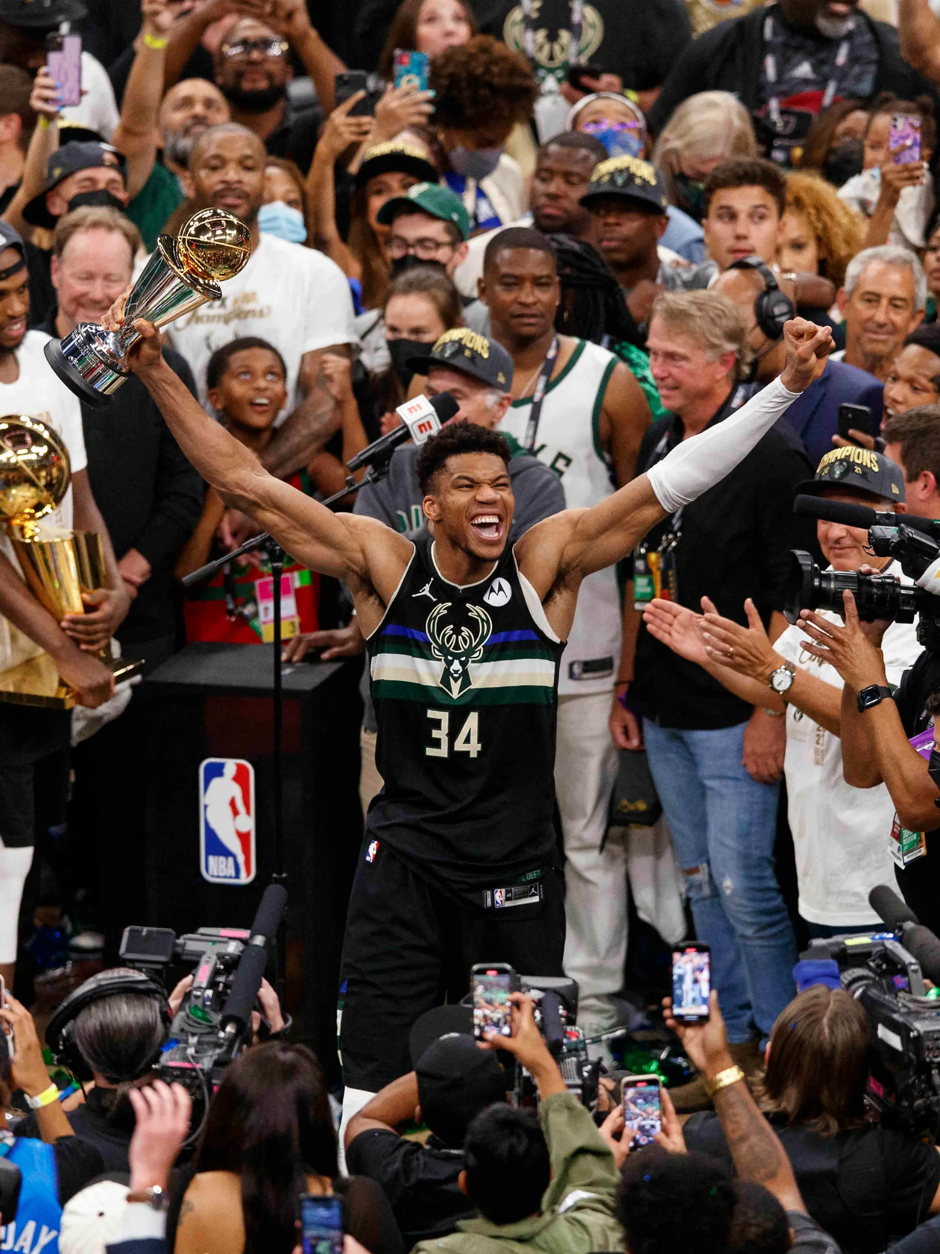 Jul 20, 2021; Milwaukee, Wisconsin, USA; Milwaukee Bucks forward Giannis Antetokounmpo (34) celebrates with the NBA Finals MVP Trophy following the game against the Phoenix Suns following game six of the 2021 NBA Finals at Fiserv Forum. Mandatory Credit: Jeff Hanisch-USA TODAY Sports