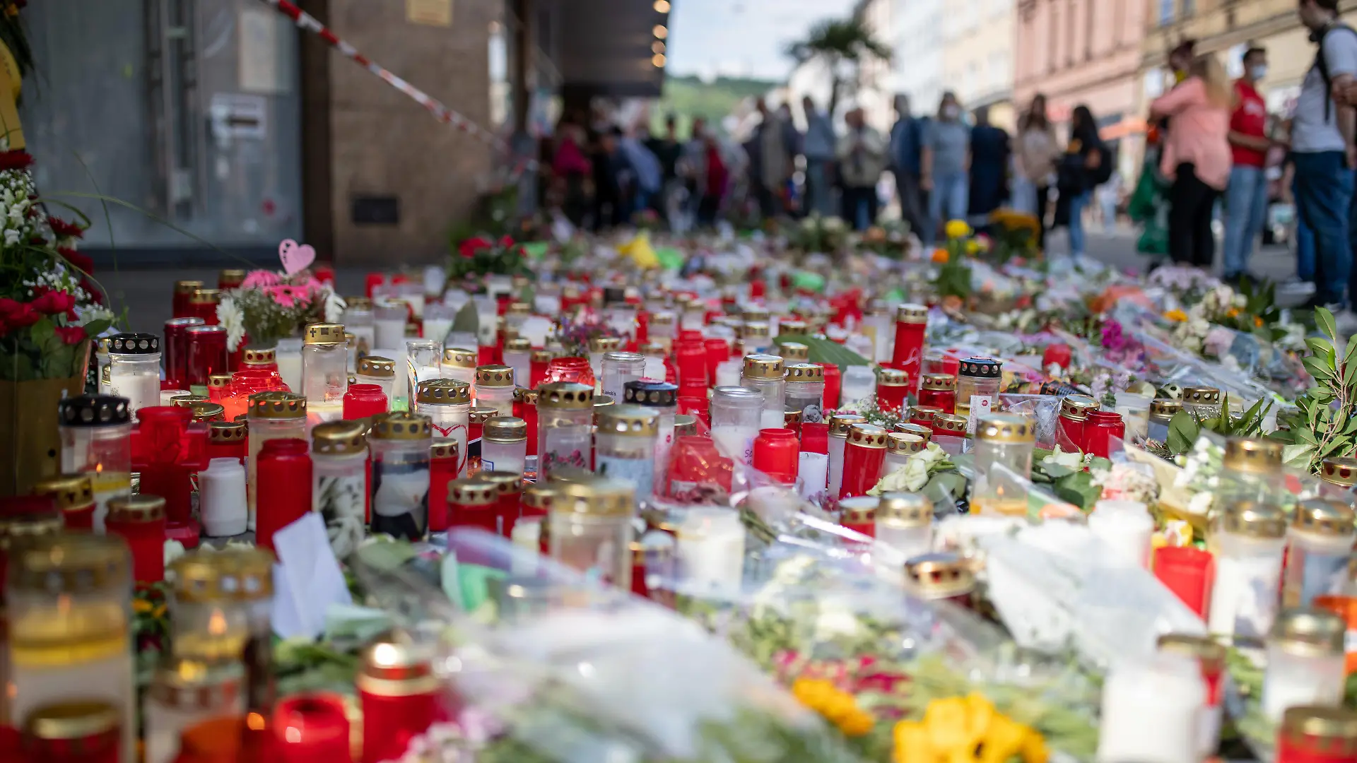 ARCHIV - 02.07.2021, Bayern, Würzburg: Grablichter, Kerzen und Blumen liegen vor einem Kaufhaus in der Innenstadt, in dem ein Mann am 25. Juni 2021 Menschen mit einem Messer attackiert und getötet hatte. Nun soll der Messerstecher in einer Psychiatrie untergebracht werden. Foto: Daniel Karmann/dpa +++ dpa-Bildfunk +++
