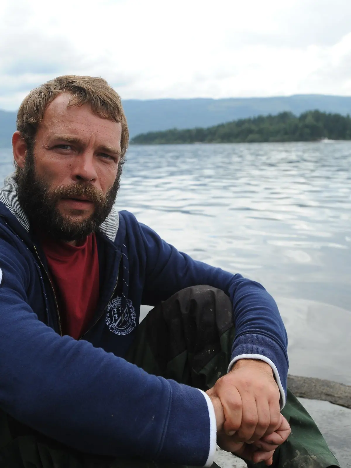 German Marcel Gleffe sits on Utvika camping ground in front of Utoya island, Norway, 24 July 2011. With his boat Gleffe saved the lives of many young people during the shooting spree on Utoya island July 22. The bombing of government buildings in Oslo and the subsequent shooting spree at a political youth camp on Utoya island on 22 July 2011 have claimed more than 90 lives with the death toll still feared to rise. Photo: Britta Pedersen dpa  +++(c) dpa - Bildfunk+++
