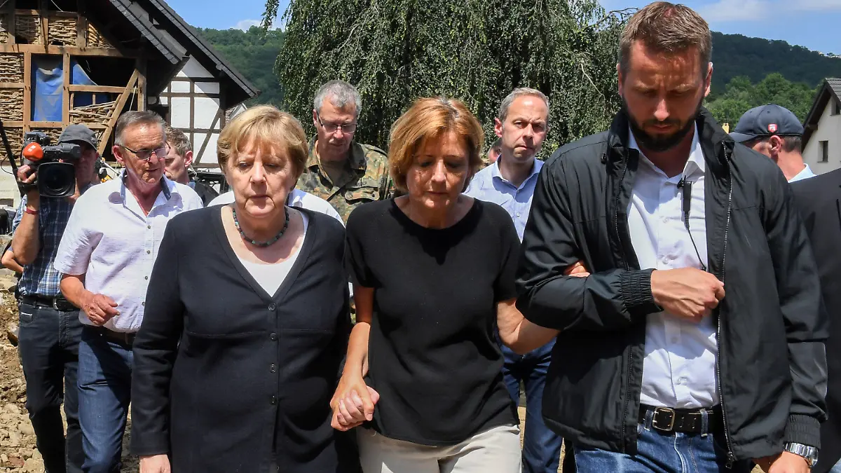 18.07.2021, Rheinland-Pfalz, Schuld: Bundeskanzlerin Angela Merkel (l) und Malu Dreyer (M,SPD), Ministerpräsidentin von Rheinland-Pfalz, gehen durch das vom Hochwasser verwüstete Dorf Schuld in der Nähe von Bad Neuenahr-Ahrweiler. Foto: Christof Stache/POOL AFP/dpa +++ dpa-Bildfunk +++