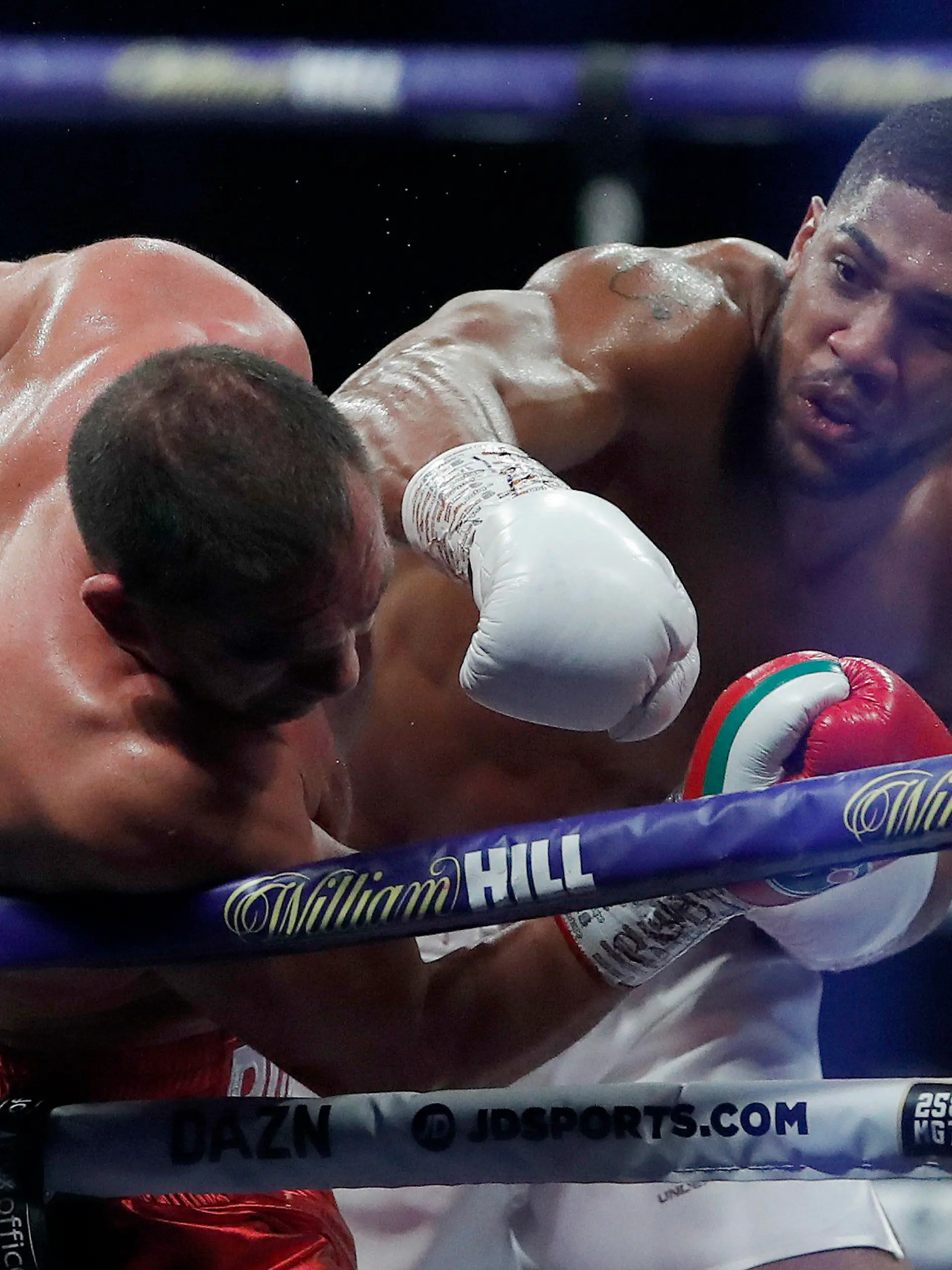 World Heavyweight boxing champion Britain's Anthony Joshua lands a blow on challenger Bulgaria's Kubrat Pulev during their Heavyweight title fight at Wembley Arena in London Saturday, Dec. 12, 2020. (Andrew Couldridge/Pool via AP)