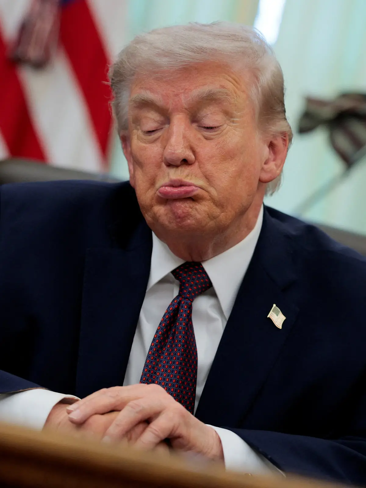 U.S. President Donald Trump reacts as he speaks during the signing ceremony for an executive order on mail ballots, in the Oval Office of the White House in Washington, D.C., March 31, 2026.  REUTERS/Evan Vucci