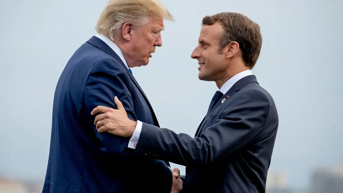 FILE - President Donald Trump and French President Emmanuel Macron greet each other at the G-7 summit before a dinner at the Lighthouse of Biarritz, France, Aug. 24, 2019. (AP Photo/Andrew Harnik, File)