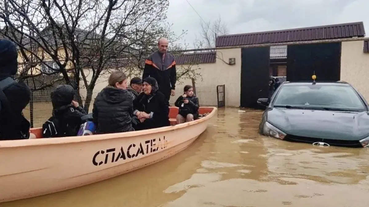 In this image made from video provided by Russian Emergency Ministry Press Service on Sunday, April 5, 2026, Emergency Situations Ministry personnel evacuate people from a flood zone in the Derbent district of the Republic of Dagestan, Russia. (Russian Emergency Ministry Press Service via AP)