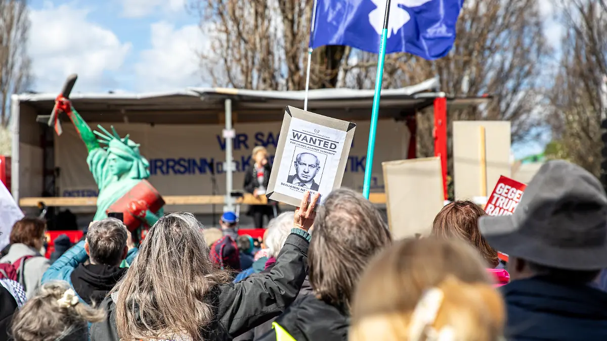 On Saturday, April 4, 2026, demonstrators gathered at Mauerpark in Berlin for an Easter peace march, where speakers and participants called for an end to military escalation and international conflicts. Protesters held signs opposing U.S. President Donald Trump, German Chancellor Friedrich Merz and Israeli Prime Minister Benjamin Netanyahu, while calling for peace and an end to what they described as war and aggression. During speeches, participants urged the closure of U.S. military bases in Germany, including Ramstein Air Base, and criticized NATO policies and increased defense spending. Demonstrators carried a range of banners and flags, including Palestinian flags, Iranian flags, and peace flags featuring dove symbols. Some signs called for an end to what protesters described as war drivers, while others expressed opposition to U.S. and Israeli military actions and showed solidarity with Russia. A Statue of Liberty prop covered in red paint and holding an oil barrel is seen among the crowd. Additional banners criticized NATO and called for diplomatic solutions instead of continued military support in ongoing conflicts. (Photo by Michael Kuenne/PRESSCOV/Sipa USA)