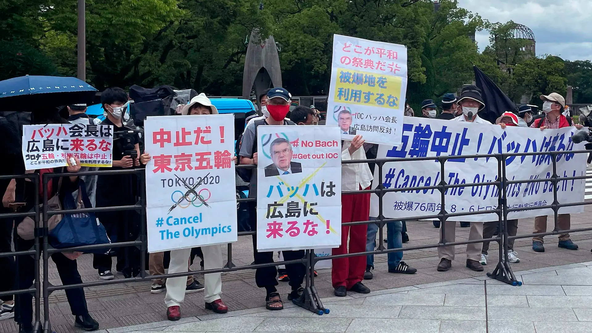 Protesters gather before International Olympic Committee President Thomas Bach visits Hiroshima Memorial Cenotaph Friday, July 16, 2021, in Hiroshima, western Japan. The banner in the center reads: "Bach, Do not come to Hiroshima!" (AP Photo/Nuga Haruka, Pool)