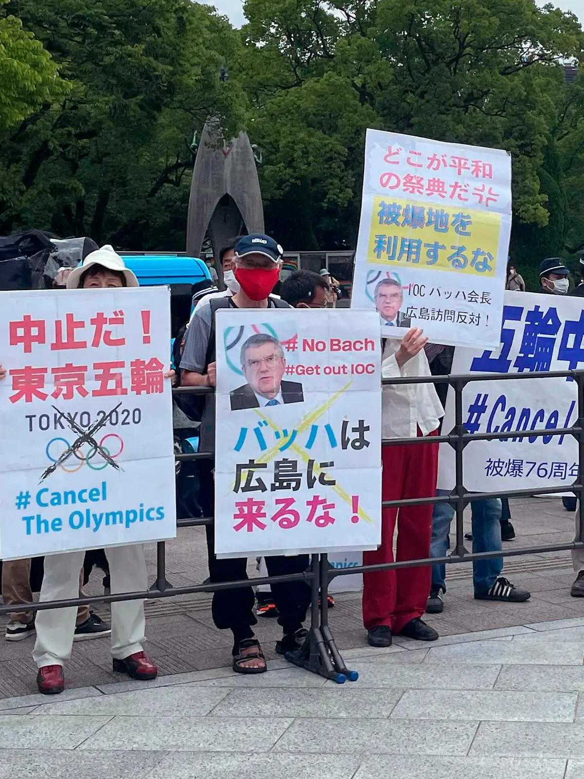 Protesters gather before International Olympic Committee President Thomas Bach visits Hiroshima Memorial Cenotaph Friday, July 16, 2021, in Hiroshima, western Japan. The banner in the center reads: "Bach, Do not come to Hiroshima!" (AP Photo/Nuga Haruka, Pool)
