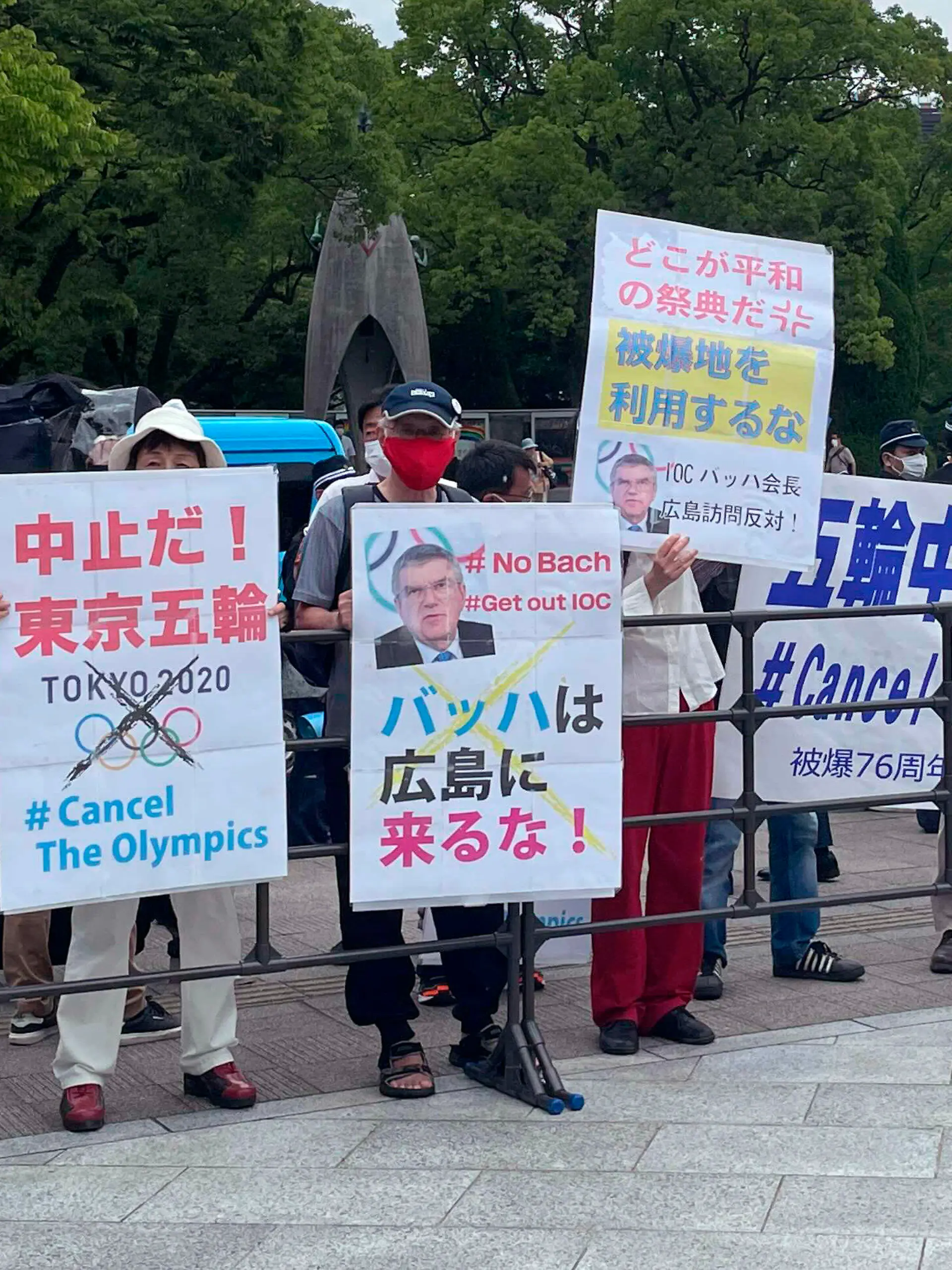 Protesters gather before International Olympic Committee President Thomas Bach visits Hiroshima Memorial Cenotaph Friday, July 16, 2021, in Hiroshima, western Japan. The banner in the center reads: "Bach, Do not come to Hiroshima!" (AP Photo/Nuga Haruka, Pool)