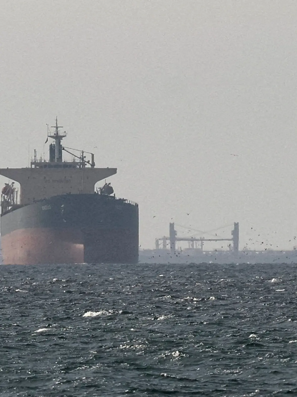 FILE PHOTO: Cargo ships in the Gulf, near the Strait of Hormuz, as seen from northern Ras al-Khaimah, near the border with Oman’s Musandam governance, amid the U.S.-Israeli conflict with Iran, in United Arab Emirates, March 11, 2026. REUTERS/Stringer/File Photo/File Photo