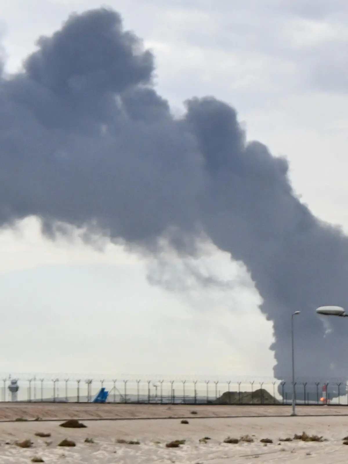 KUWAIT CITY, KUWAIT - MARCH 25: Smoke rises after Iranian-sourced unmanned aerial vehicle (UAV) carried out an attack on a fuel depot at Kuwait International Airport in Kuwait City, Kuwait on March 25, 2026. Stringer / Anadolu