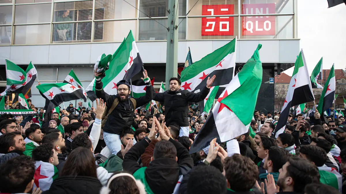 On Sunday, December 7, 2025, large crowds of Syrians gather at Alexanderplatz in Berlin, Germany, waving Syrian and German flags and chanting "Freedom for Syria" ahead of Monday's anniversary marking the fall of the country's former Assad regime. Many young people joined the celebration, which drew families, activists, and members of the Syrian diaspora, who expressed hope and solidarity (Photo by Michael Kuenne/PRESSCOV/Sipa USA)