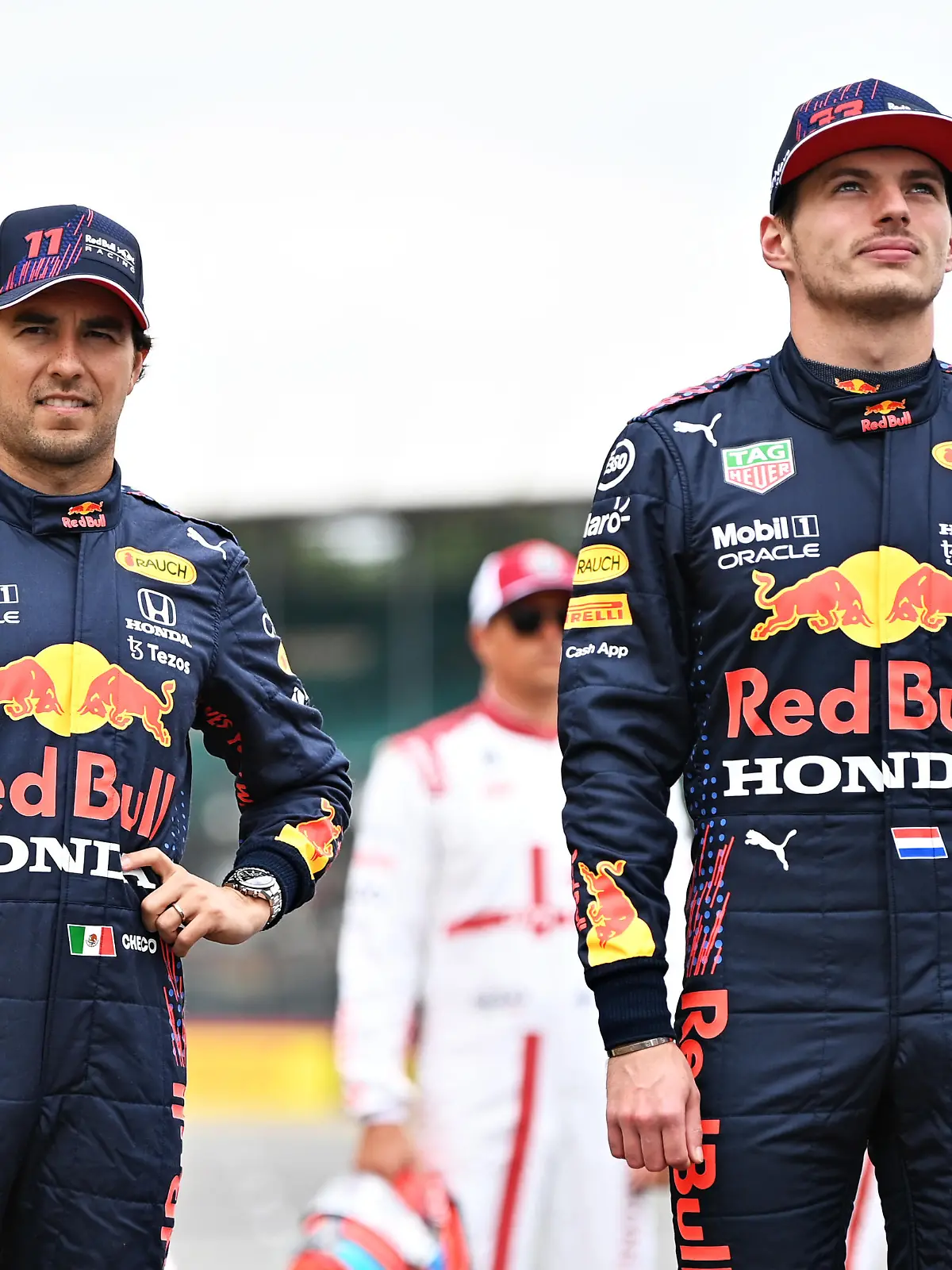 NORTHAMPTON, ENGLAND - JULY 15: Sergio Perez of Mexico and Red Bull Racing and Max Verstappen of Netherlands and Red Bull Racing look on as the prototype for the 2022 F1 season is unveiled during previews ahead of the F1 Grand Prix of Great Britain at Silverstone on July 15, 2021 in Northampton, England. (Photo by Michael Regan/Getty Images)