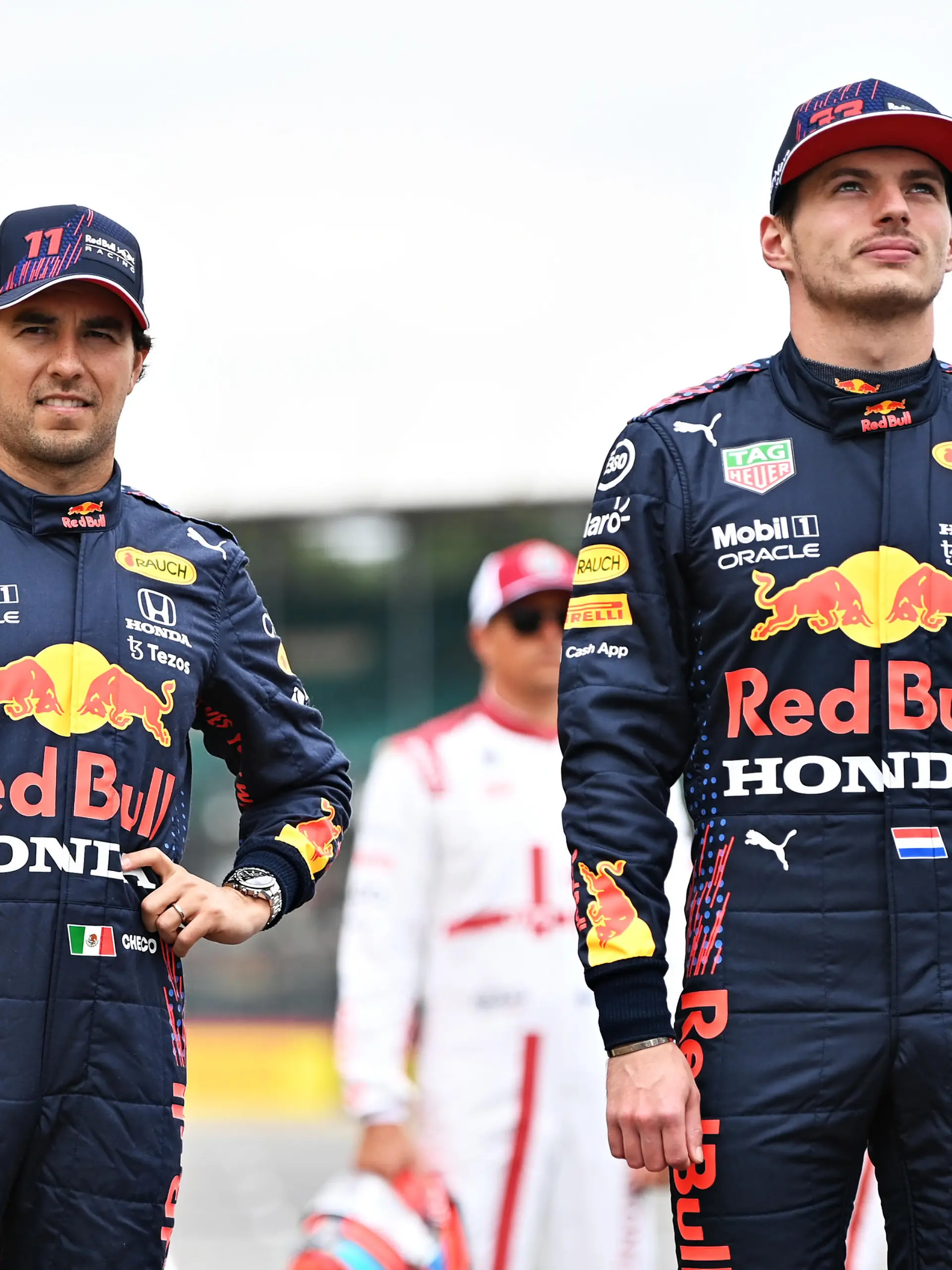 NORTHAMPTON, ENGLAND - JULY 15: Sergio Perez of Mexico and Red Bull Racing and Max Verstappen of Netherlands and Red Bull Racing look on as the prototype for the 2022 F1 season is unveiled during previews ahead of the F1 Grand Prix of Great Britain at Silverstone on July 15, 2021 in Northampton, England. (Photo by Michael Regan/Getty Images)