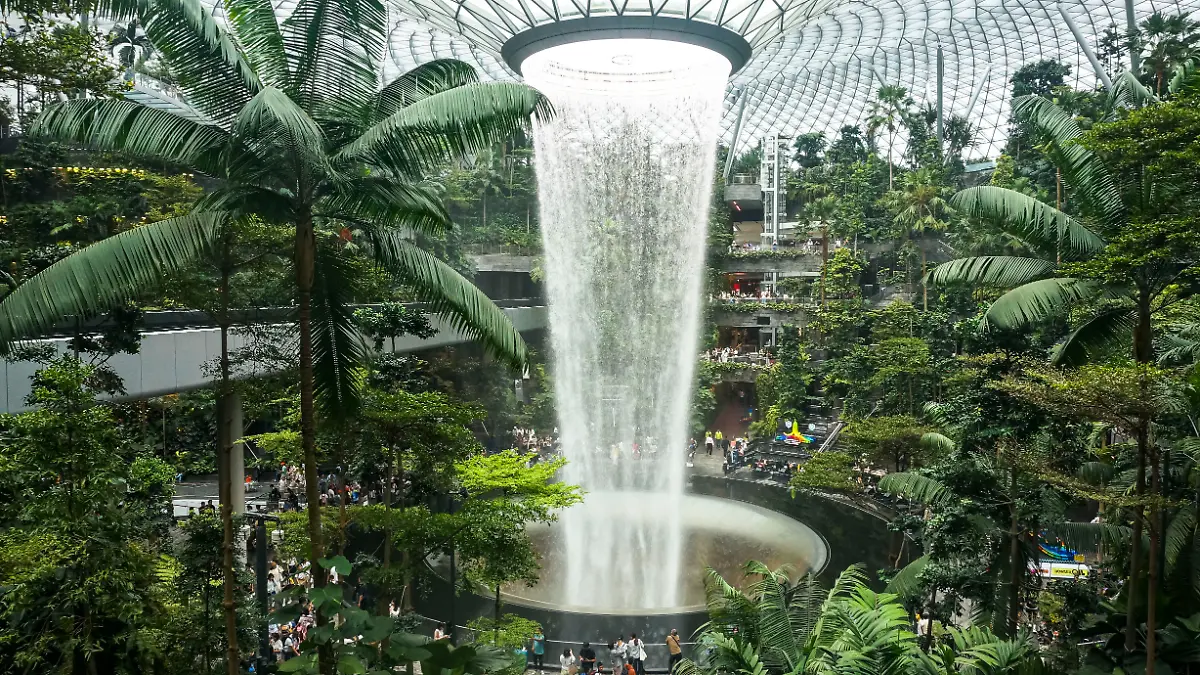 People visit the Rain Vortex indoor waterfall feature at Jewel Changi Airport mall in Singapore on July 11, 2025. (Photo by Agoes Rudianto/NurPhoto)