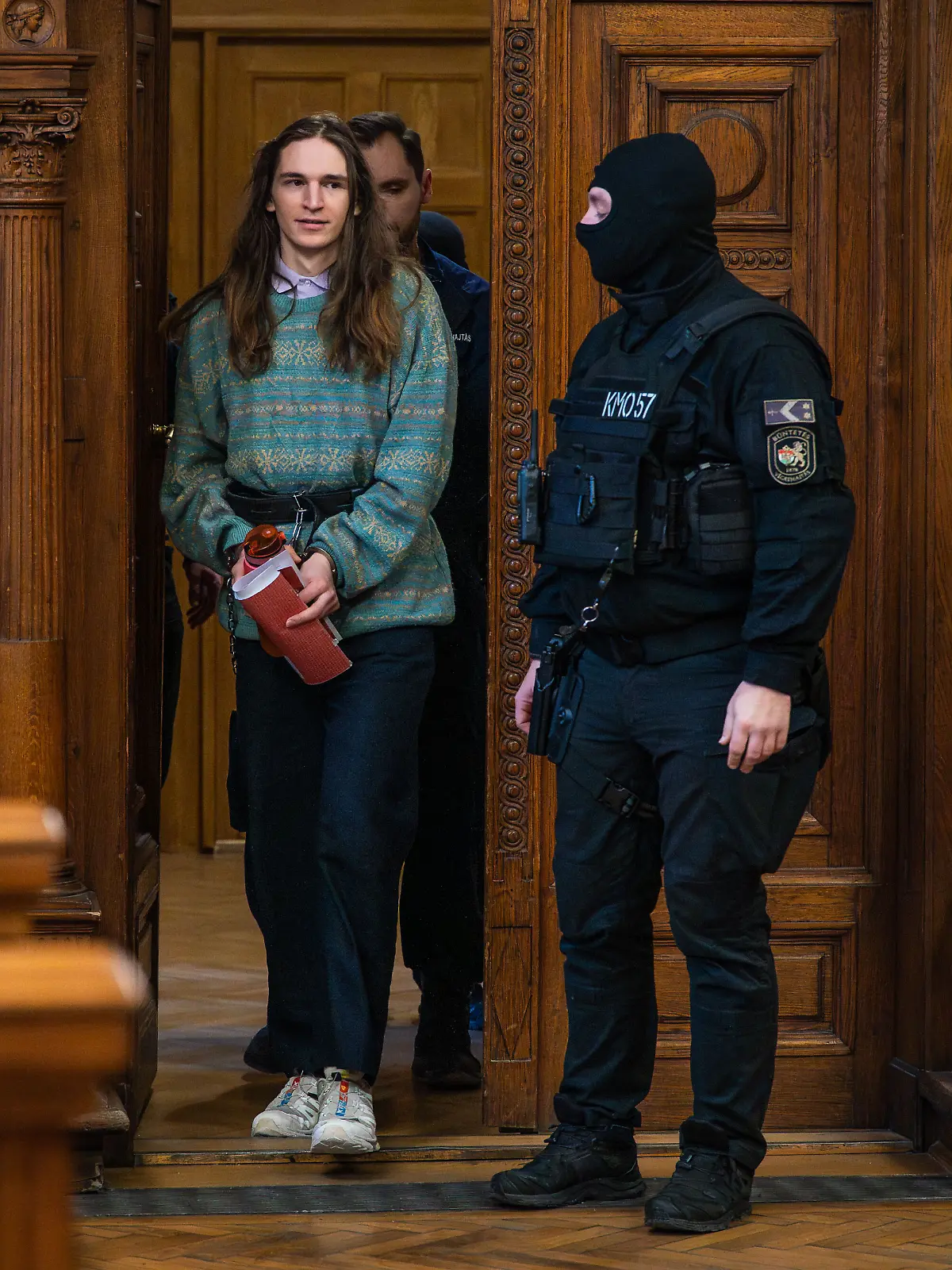 January 22, 2026, Budapest, Budapest, Hungary: MAJA T., a German anti-fascist activist entering the Budapest-Capital Regional Court during a trial hearing under heavy guard. The antifa activist has been in custody in Hungary for many months now, where years of prison could await them if found guilty in a violent attack of far-right supporters after their rally back in 2023, in Budapest. (Credit Image: © Daniel Alfoldi/ZUMA Wire