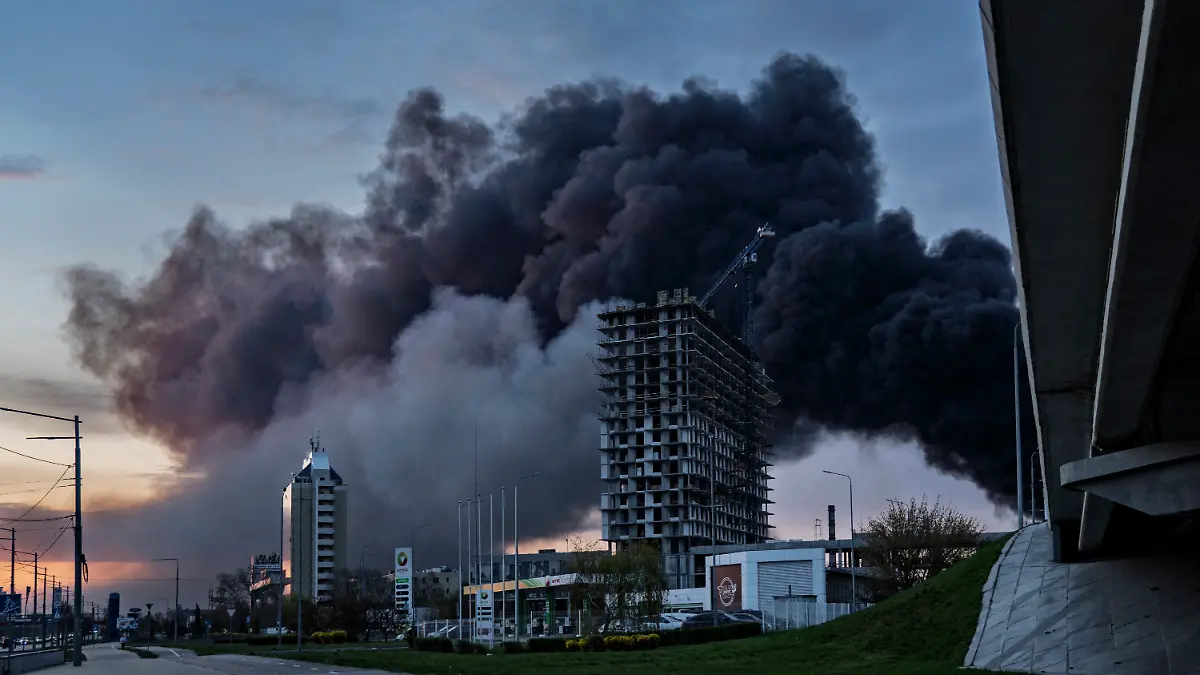 Smoke rises over Kyiv following a Russian strike on April 16, 2026, amid the Russian invasion of Ukraine. Russian strikes killed at least 12 people in Ukraine, local authorities said on April 16, after Moscow pummelled its neighbour in overnight attacks. (Photo by Serhii Okunev / AFP)