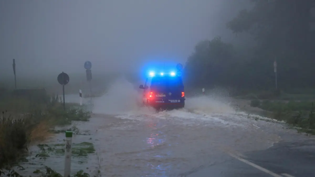 A vehicle travels on a flood affected road after the Erft river swelled following heavy rainfalls in Erftstadt, near Cologne, Germany, July 15, 2021. REUTERS/Wolfgang Rattay