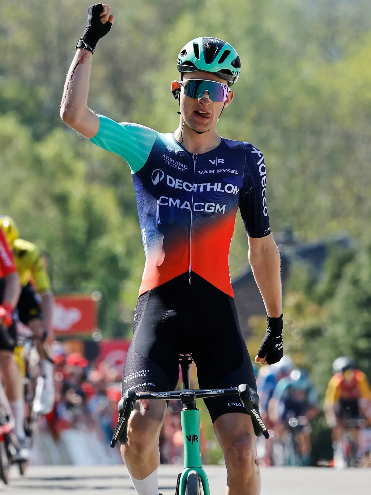Paul Seixas of France crosses the finish line ahead of Benoit Cosnefroy of France, far left, Mauro Schmid of Switzerland, second left, and Ben Tulett of Britain, rear in yellow, to win the Belgian cycling classic Fleche Wallonne (Walloon Arrow), in Huy, Belgium, Wednesday, April 22, 2026. (AP Photo/Geert Vanden Wijngaert)
