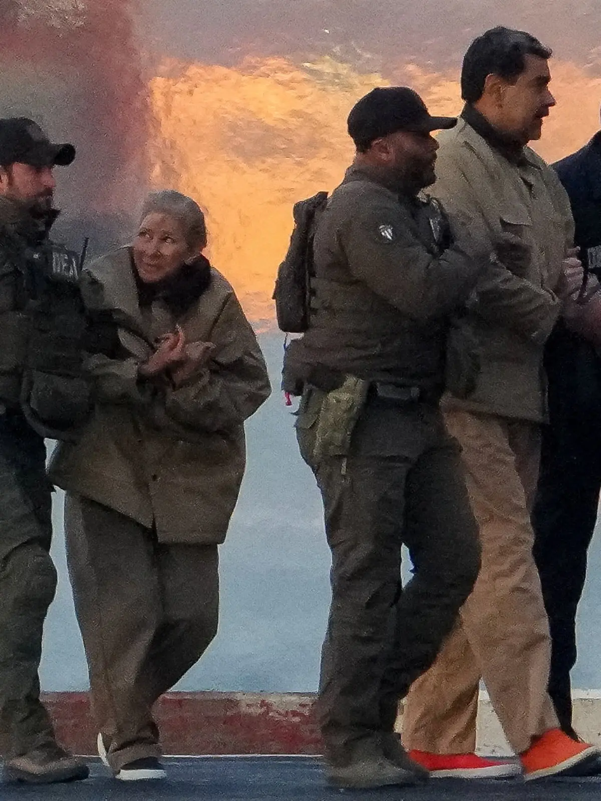 DEA (Drug Enforcement Administration) agents move captured Venezuelan President Nicolas Maduro and his wife Cilia Flores out of a helicopter, as Nicolas Maduro heads towards the Daniel Patrick Manhattan United States Courthouse for an initial appearance to face U.S. federal charges including narco-terrorism, conspiracy, drug trafficking, money laundering and others in New York City, U.S., January 5, 2026. REUTERS/Adam Gray