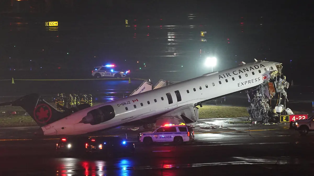 Emergency crews work around an Air Canada Express jet that had collided with a ground vehicle at New York's La Guardia Airport in Queens, New York, U.S. March 23, 2026.  REUTERS/Bing Guan     TPX IMAGES OF THE DAY