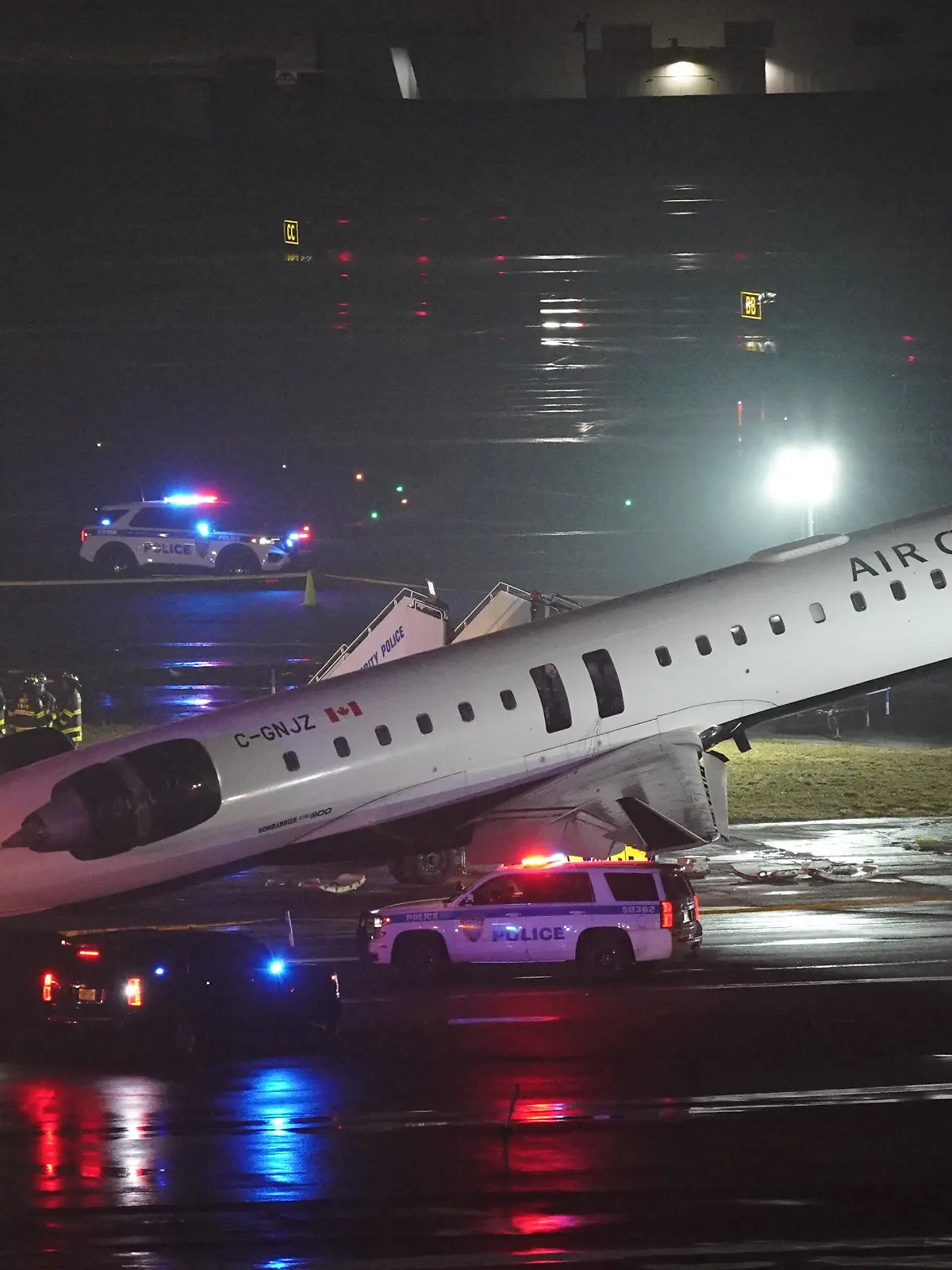Emergency crews work around an Air Canada Express jet that had collided with a ground vehicle at New York's La Guardia Airport in Queens, New York, U.S. March 23, 2026.  REUTERS/Bing Guan     TPX IMAGES OF THE DAY