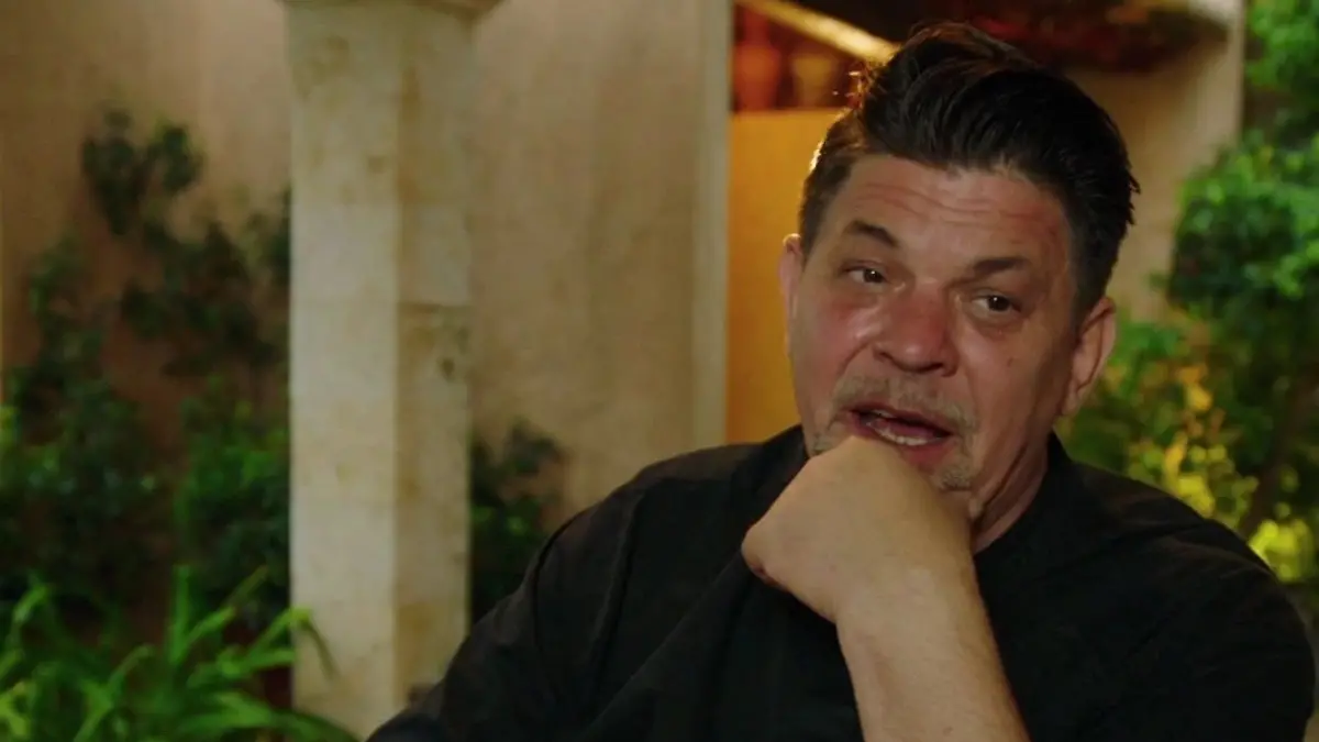 Tim zeigt mit dem Finger auf den Teller vor ihm.