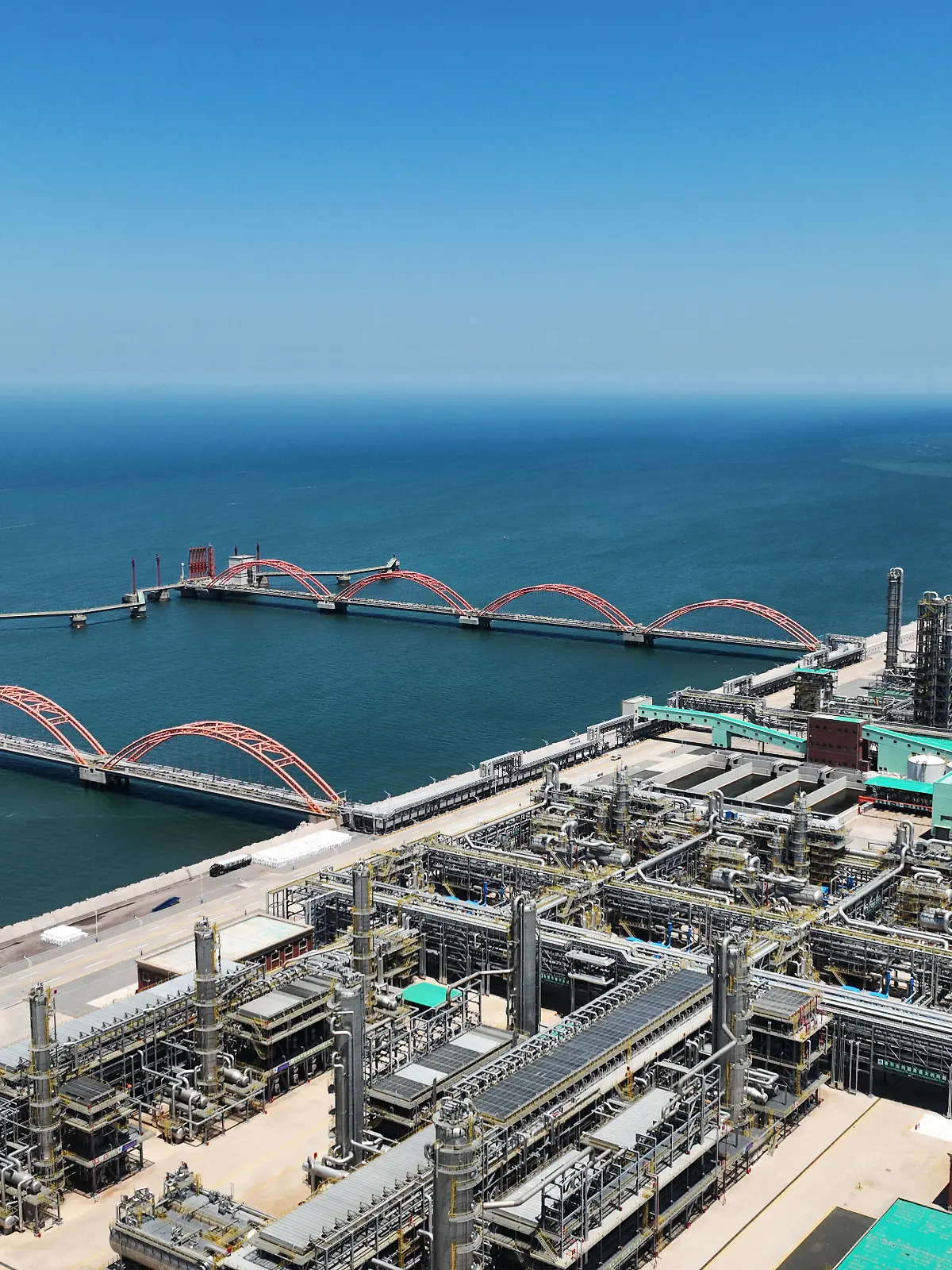 (240810) -- SHENYANG, Aug. 10, 2024 (Xinhua) -- An aerial drone photo taken on June 16, 2024 shows a view of a petrochemical industrial park of Hengli Group on Changxing Island of Dalian, northeast China's Liaoning Province. The petrochemical industry, as a pillar industry of the country's northeastern provinces, has optimized industrial structure in recent years to promote high-quality development. (Xinhua/Yang Qing)