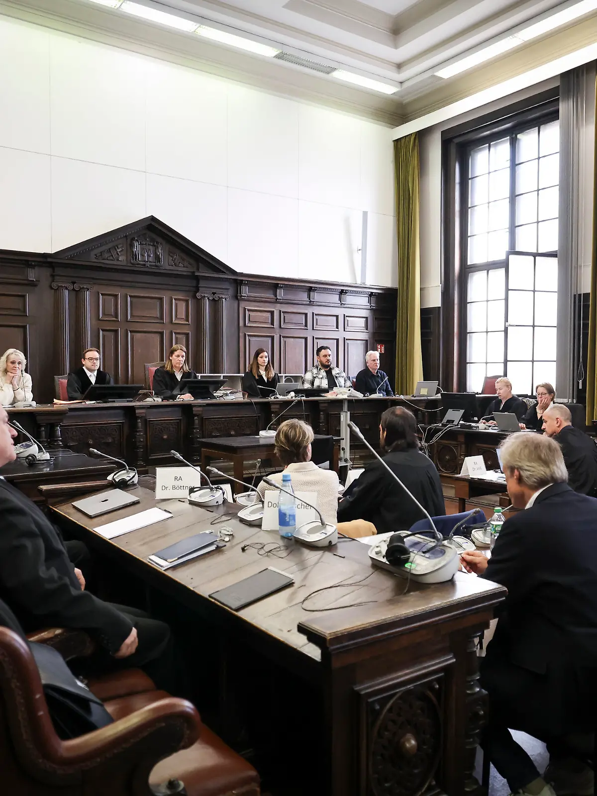 27.04.2026, Hamburg: Richterin Isabel Hildebrandt (hinten, 5.v.l), Vorsitzende Richterin am Landgericht, und weitere Prozessbeteiligte sitzen zu Beginn eines weiteren Prozesstages im Prozess wegen mutmaßlicher Kindesentführung im Gerichtssaal im Strafjustizgebäude. In einer Nacht-und-Nebel-Aktion wurden in der Silvesternacht 2023/24 zwei Kinder der Gastronomie-Unternehmerin Block von Dänemark nach Deutschland gebracht. Wegen der mutmaßlichen Entführung findet am Landgericht Hamburg der Prozess statt, unter anderem gegen Block. Foto: Christian Charisius/dpa-Pool/dpa +++ dpa-Bildfunk +++