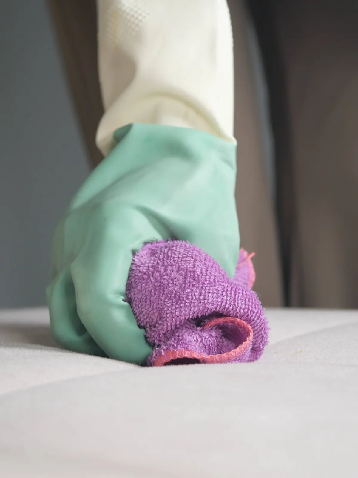 Cleaning a mattress with a cloth and rubber gloves in a bedroom A person cleans a mattress using a cloth while wearing gloves., 94659206.jpg RECORD DATE NOT STATED