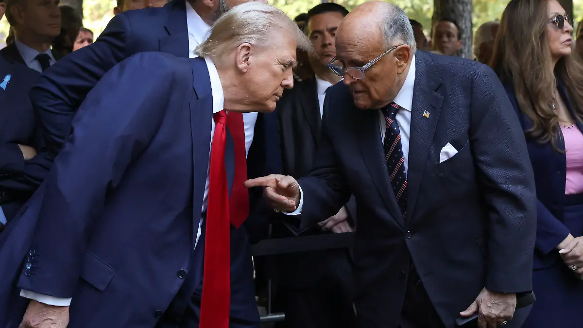 Republican presidential nominee former President Donald Trump, left, talks with former New York City mayor Rudy Giuliani while attending the 9/11 Memorial ceremony on the 23rd anniversary of the Sept. 11, 2001 attacks, Wednesday, Sept. 11, 2024, in New York. (AP Photo/Yuki Iwamura)