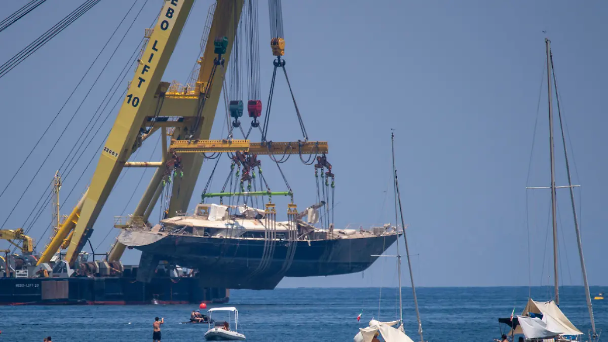 The hull of the superyacht Bayesian, which sank near Palermo, Sicily, on August 19, 2024, is pulled out of the sea off the village of Porticello to be taken to the nearby shipyard in Termini Imerese, Sunday, June 22, 2025. (AP Photo/Salvatore Cavalli)