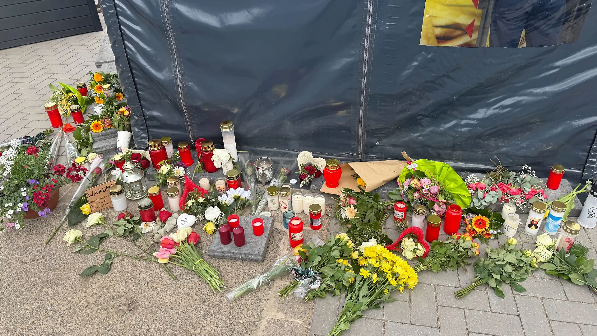 Vor dem Bratwurststand von Dana A. und Jan C. werden Blumen niedergelegt