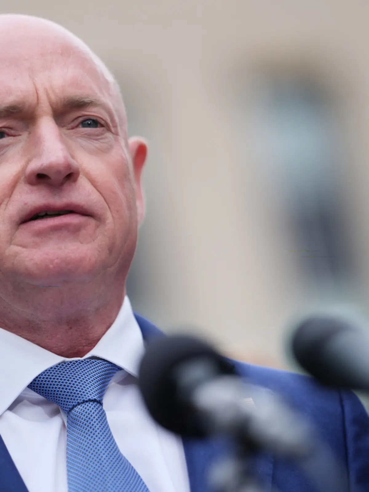Sen. Mark Kelly, D-Ariz., speaks with reporters outside the E. Barrett Prettyman Federal Courthouse, Thursday, May 7, 2026, in Washington. (AP Photo/Julia Demaree Nikhinson)