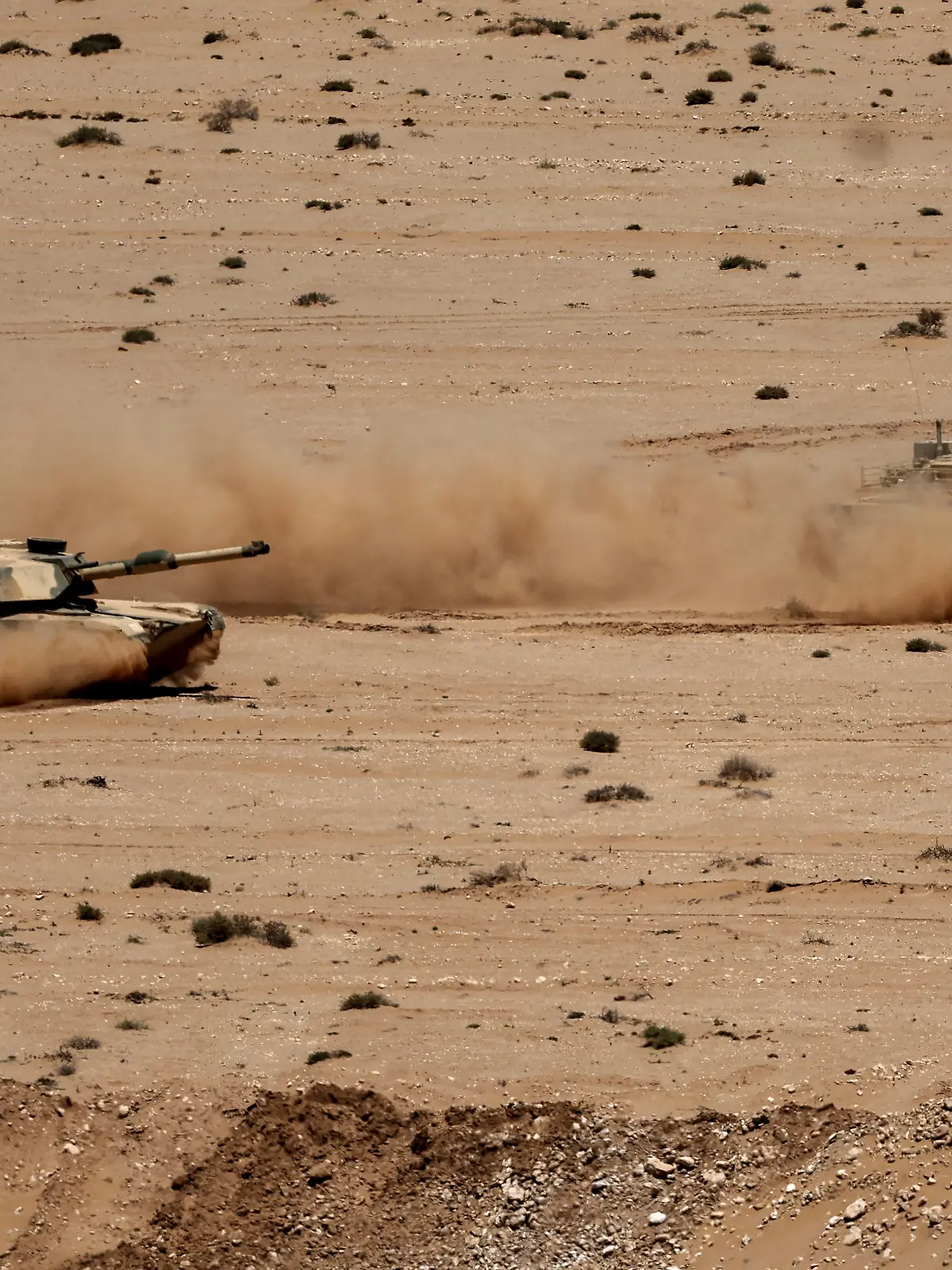 Battle tanks drive in formation during the "African Lion" joint military exercise between US and Moroccan forces in the Tan-Tan region in southwestern Morocco on May 8, 2026. (Photo by Abdel Majid BZIOUAT / AFP)