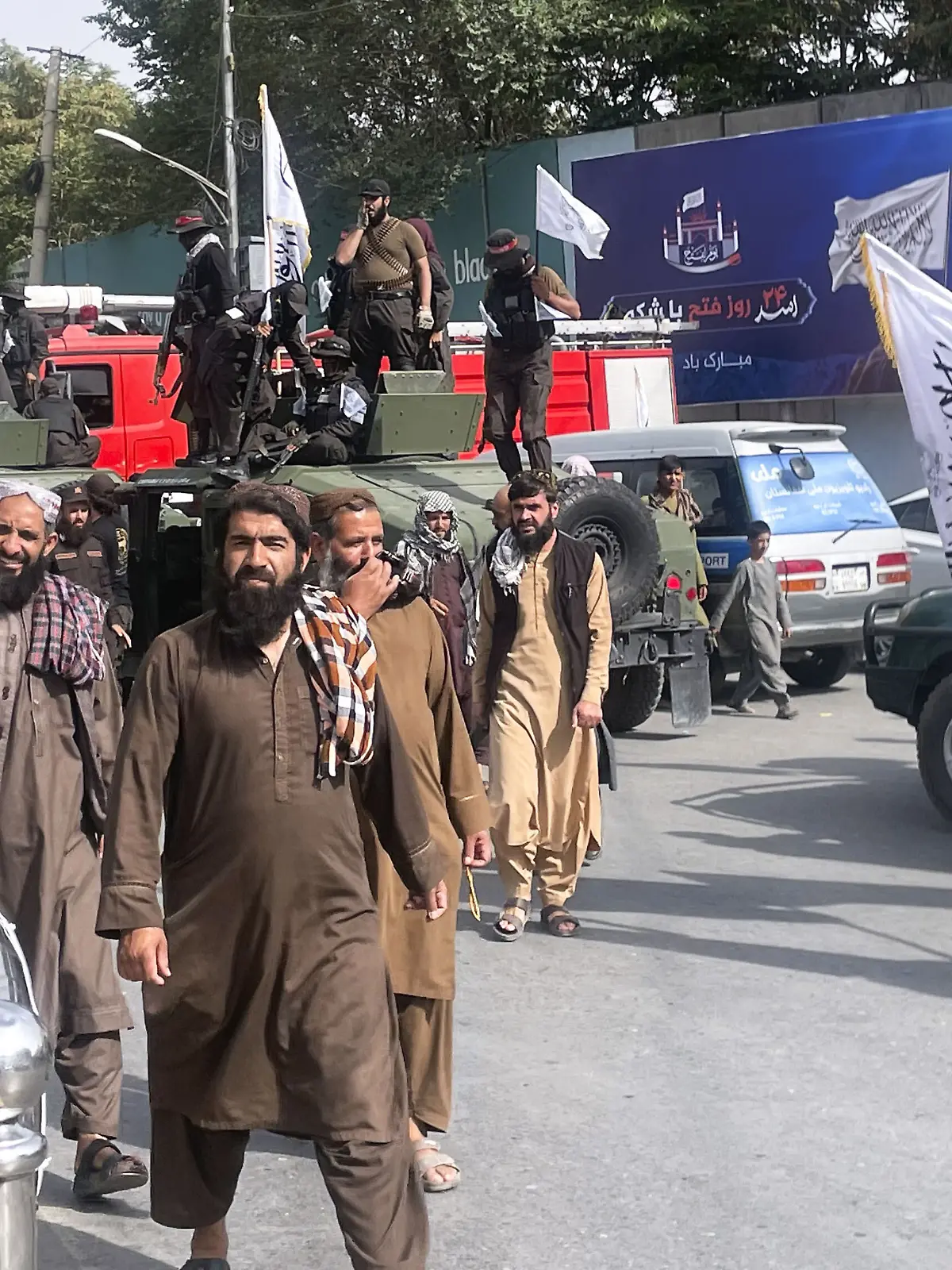 Taliban security officers and supporters celebrate the fourth anniversary of the group's return to power in Kabul on Aug. 15, 2025. (Kyodo)