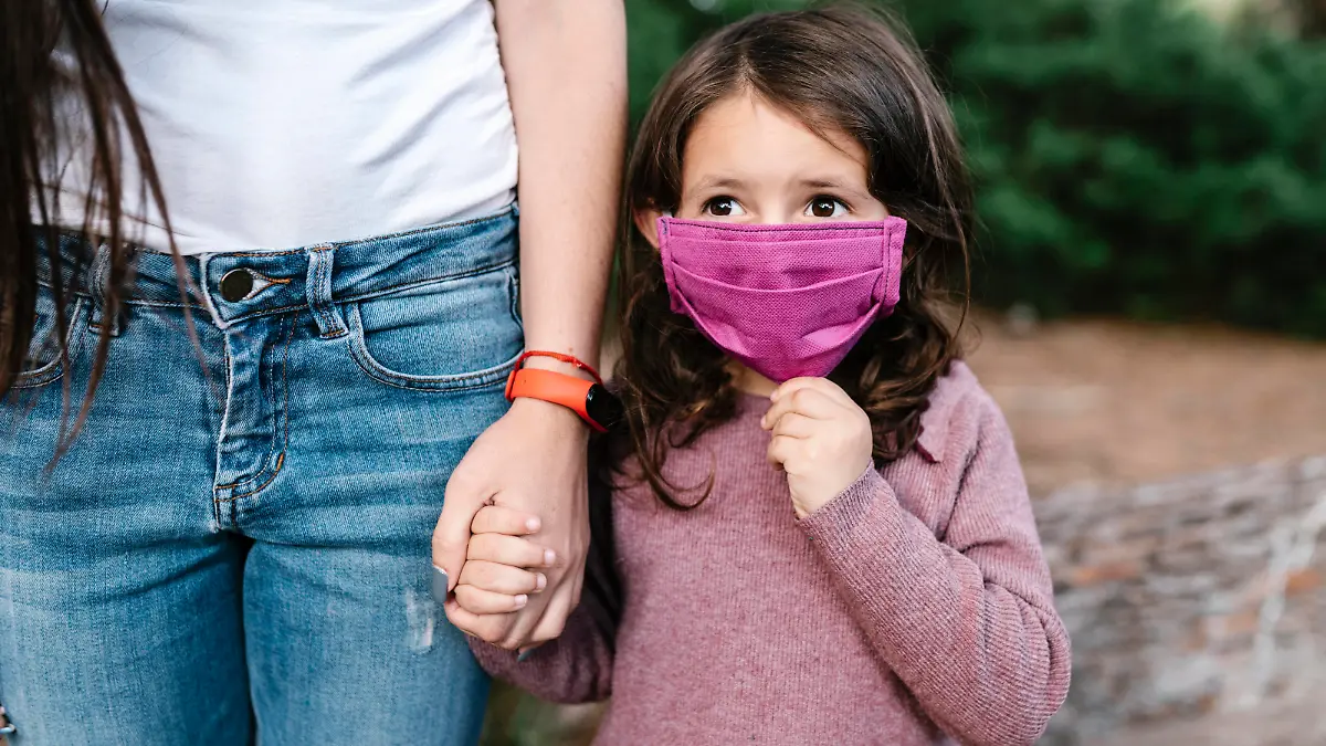  Daughter wearing protective mask and holding hand of her mother model released Symbolfoto EGAF00272